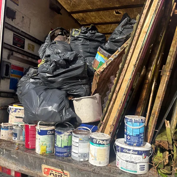 Black rubbish bags and old timber loaded in the van