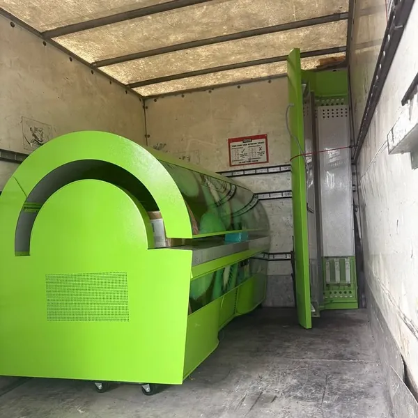 A large green unit loaded in the van for a move