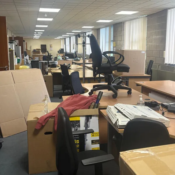 Desks, office chairs and boxes during an office clear-out