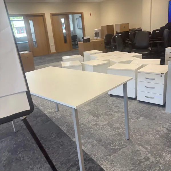 Desks and white drawer units waiting to go