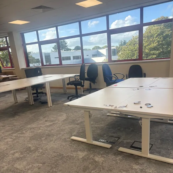 Office desks and chairs by the windows, still to go