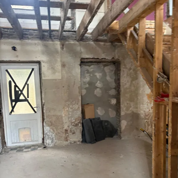 A ground floor room stripped back to the bare walls